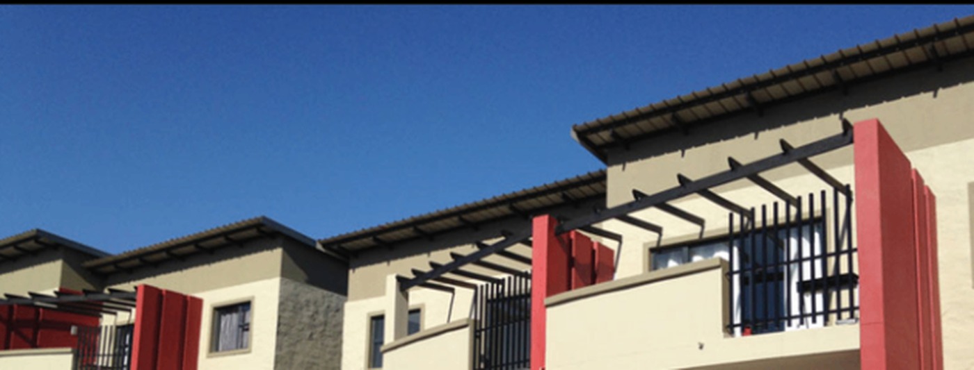 North Gate Housing — angled facade with red accent screens